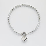 Срібне серце на світло-сірих перлах