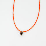 Orange beaded necklace with small shell