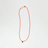 Orange beaded necklace with small shell