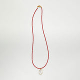 Red beaded necklace with crystal pendant