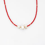 Red beaded necklace with 3 pearls